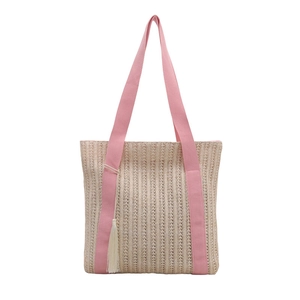 Beige woven straw tote bag with pink textile straps and white tassel decoration