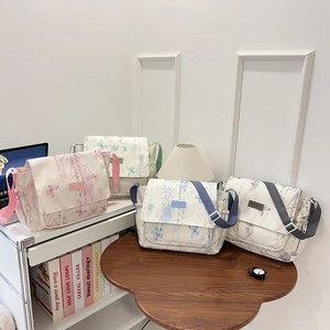 Minimalist canvas messenger bags in four pastel colors with nature-inspired prints