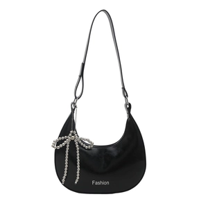 Minimalist black crescent hobo shoulder bag with a silver beaded bow charm and fashion logo