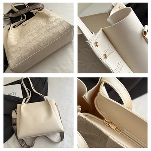 Detail of cream tote bag featuring crocodile texture, gold rivets and woven shoulder strap