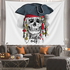 Detail of Halloween pirate skull tapestry with decorative feathers and coins on wall