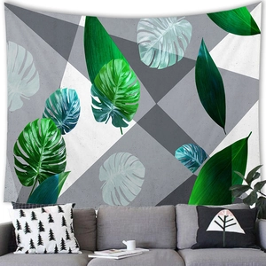 Detail of tropical monstera leaf wall tapestry over a modern gray sofa