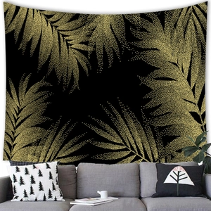 Detail of black and gold palm leaf tapestry with bohemian golden dot patterns