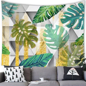 Close-up of tropical leaf tapestry featuring golden edges and geometric patterns on fabric