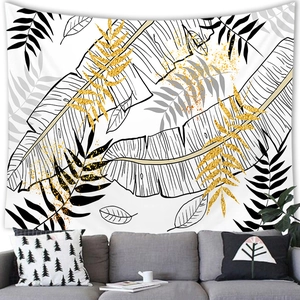 Nordic style tropical leaf wall tapestry with golden texture over a grey sofa decor