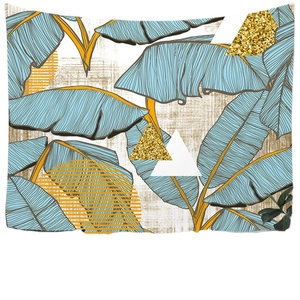 Modern wall tapestry featuring blue tropical leaves and gold geometric patterns