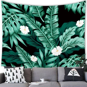 Tropical monstera and palm leaf wall tapestry for home decor above a modern sofa
