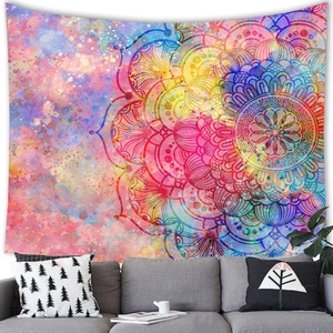 Close-up of a colorful watercolor mandala tapestry on a wall above a modern grey sofa