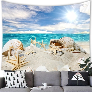 Detail of beach tapestry featuring sea shells and starfish hung over a grey sofa