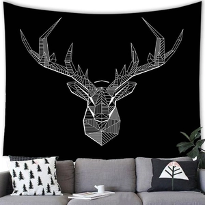 Detail of a minimalist elk head wall tapestry hanging above a modern living room sofa