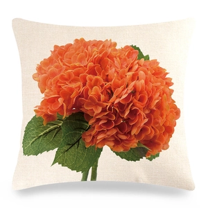 Close-up of the woven linen texture and orange hydrangea print on square pillowcase