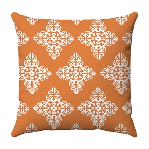 Detailed fabric texture of orange square pillowcase with white geometric floral patterns