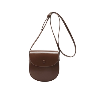 Minimalist dark brown leather saddle bag with round flap and adjustable shoulder strap