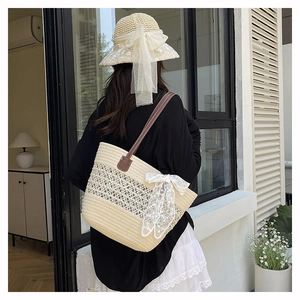 Detailed view of handmade woven straw bag with lace bow decoration and faux leather straps