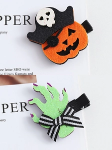 Detail of Halloween hair clips featuring a pirate pumpkin and glittery zombie hand design