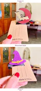 Detail of Halloween hair clips featuring glittery moon bat and wizard hat designs