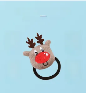 Detailed view of a brown knitted reindeer plush hair tie with a red nose and black elastic band