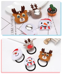 Close-up detail of plush Christmas-themed brooch pins and soft elastic hair bands