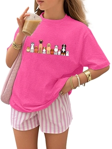 Close-up of pink round neck kids t-shirt featuring vibrant colorful cartoon dog prints