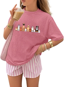 Detail of soft cotton pink kids t-shirt with cute cartoon dogs and striped shorts
