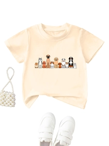 Detail of cute cartoon dog prints on a light beige short sleeve cotton kids T-shirt