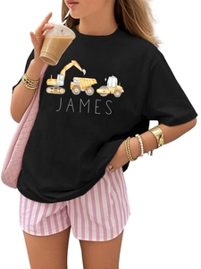 Detailed view of kids custom black T-shirt featuring yellow construction vehicle prints