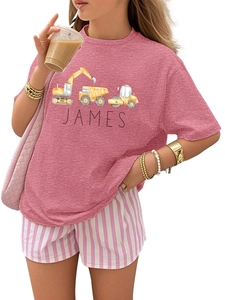 Close-up of pink T-shirt featuring custom James name and cartoon construction trucks