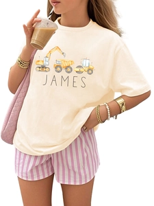 Detail of kids white cotton t-shirt with James name and yellow construction truck prints