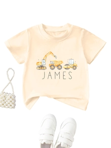 Detailed view of beige kids t-shirt with cartoon construction trucks and James name