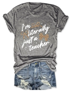 Detailed close-up of grey 'I'm literally just a teacher' T-shirt with leopard bows