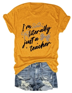 Detail of yellow teacher slogan t-shirt paired with frayed denim shorts on white background