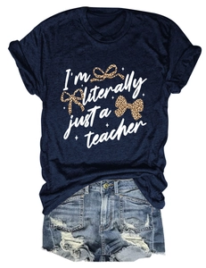 Flat lay of teacher graphic t-shirt with leopard bows and distressed denim shorts