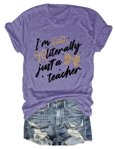 Detail of purple graphic tee with slogan and bow, paired with ripped denim shorts