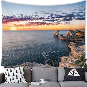 Detail of tropical sunset beach tapestry hanging above a sofa for home wall decoration