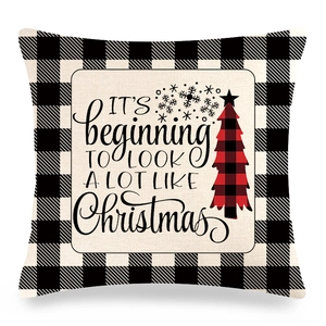 Detail of Christmas buffalo plaid linen pillowcase with holiday text and tree print