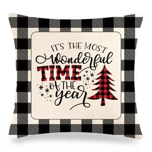 Detail of linen Christmas pillow case with black buffalo plaid and festive typography
