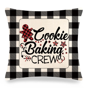 Detail of buffalo plaid Christmas pillow cover featuring Cookie Baking Crew gingerbread print