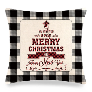 Detail of Christmas buffalo plaid pillow cover with festive text and fabric texture