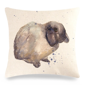 Close-up of linen cushion cover showing watercolor bunny print and fabric texture