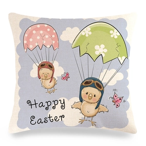 Detail of linen Easter pillow cover with cartoon chick and Happy Easter print