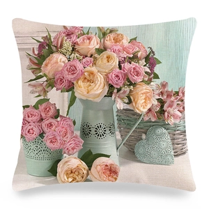 Close-up of linen pillow cover featuring vintage floral pattern with pink roses