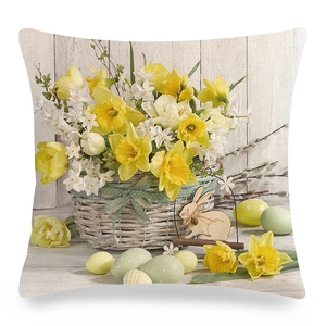 Easter pillow cover with yellow daffodils, woven basket and colorful eggs on linen