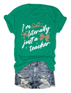 Flat lay of green t-shirt with teacher quote print and distressed denim shorts outfit