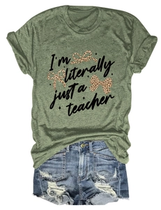Close-up of olive green t-shirt with teacher text and leopard bows on white background