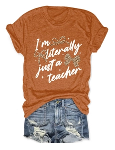 Flat lay of orange teacher T-shirt with leopard bows and distressed denim shorts