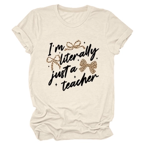 Close-up of cream crewneck t-shirt with leopard bow prints and teacher slogan