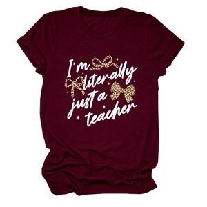 Detail of burgundy T-shirt showing I'm literally just a teacher text and leopard bows