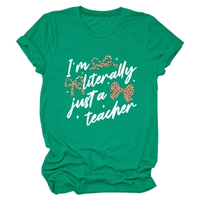 Close-up of green teacher T-shirt with I'm literally just a teacher print and leopard bows