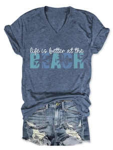 Detail of V-neck T-shirt with Beach lettering and distressed denim shorts set