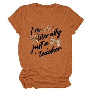 Close-up of rust-orange T-shirt fabric with teacher text and leopard bows detail
